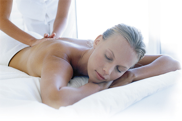 Woman on a massage table receiving a back massage