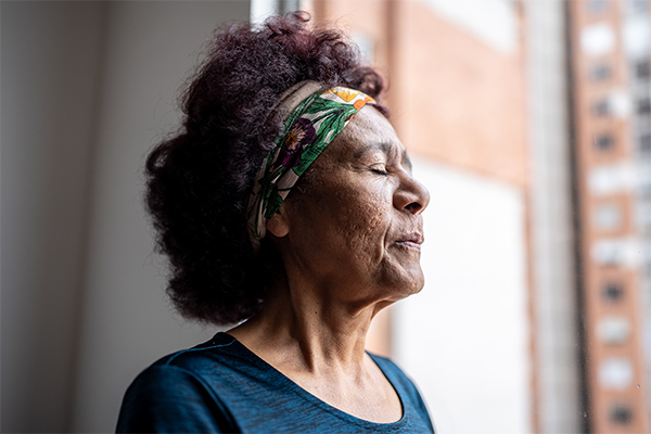 Woman takes a moment to herself and practices her breathing.