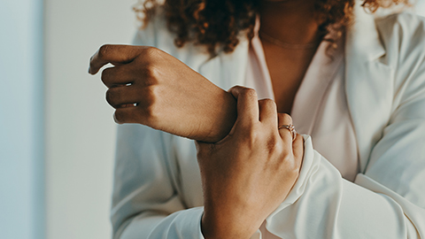 A woman holding her wrist in pain.