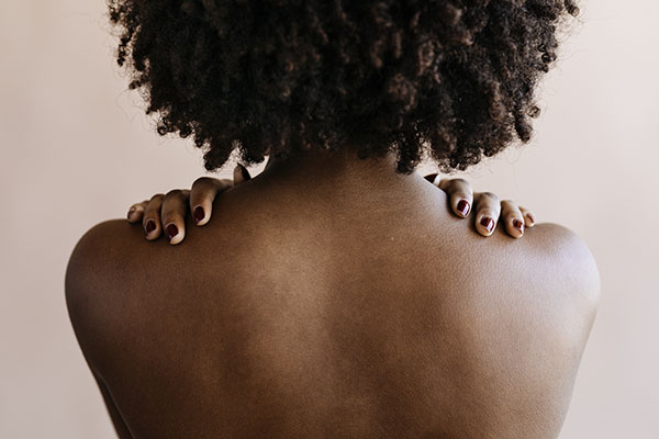 An African-American woman with her back to the camera