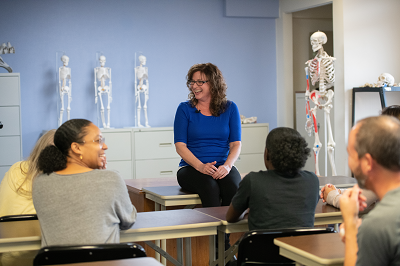 students sitting in front of a teacher