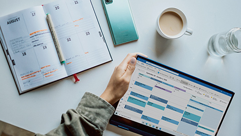 Massage scheduling software on a tablet and an open calendar with appointments.