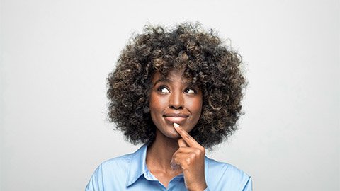 Image of a woman with her finger to her chin thinking.