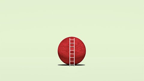 A white ladder resting against a big red ball.