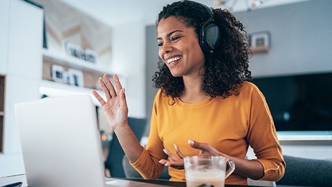 A woman at a computer in a virtual meeting 