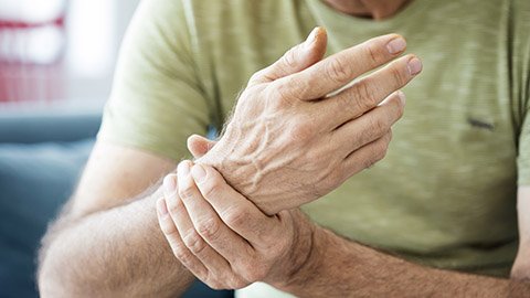 Man rubbing a painful wrist.